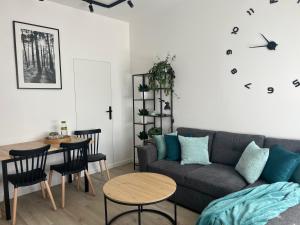 a living room with a couch and a table at Zielono Mi in Szczecin