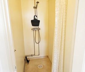 a shower in a bathroom with a shower curtain at Large House with Two Apartments in Central Skarhamn in Skärhamn +30 photos