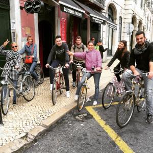 
people riding bikes down a street at Lookout Lisbon Hostel in Lisbon
