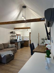 a living room with a couch and a table at Somló Éden in Somlószőlős
