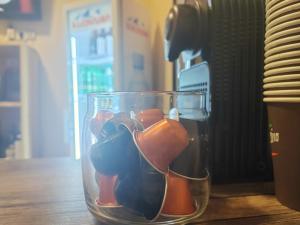 a glass vase filled with different colored figurines on a table at Hotel Svanseti in Mestia