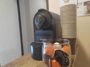 a camera and a glass of fruit on a table at Hotel Svanseti in Mestia