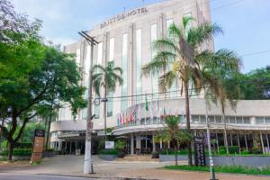 サントアンドレにあるBristol Santo André ABC São Pauloのヤシの木が前に生えている大きな建物