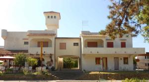 a large white building with a tower on top of it at Apartment in Rosolina Mare 25092 in Rosolina Mare