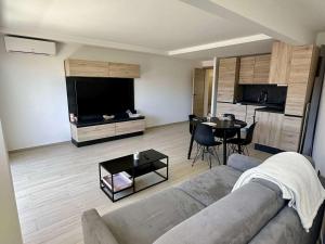 a living room with a couch and a table at Appartement 2 pièces à Cavalaire avec Climatisation et Parking privé - FR-1-226B-216 in Cavalaire-sur-Mer