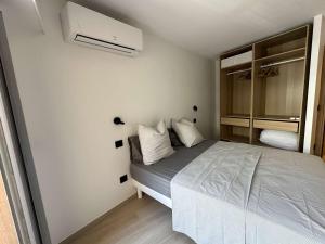 a small bedroom with a bed and a fan at Appartement 2 pièces à Cavalaire avec Climatisation et Parking privé - FR-1-226B-216 in Cavalaire-sur-Mer