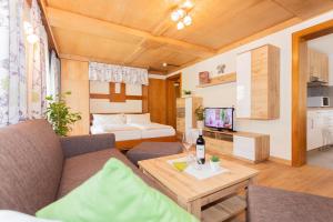 a living room with a couch and a table at Rainberghof***, Appartements in Rauris
