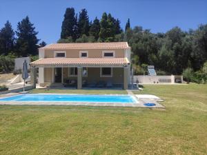 a house with a swimming pool in a yard at Private Villa Maothis in Corfu Town
