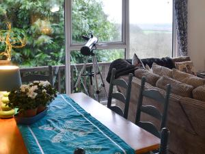 ein Wohnzimmer mit Tisch und Couch in der Unterkunft Timbers in Woolfardisworthy