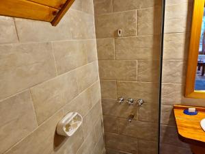 a bathroom with a shower with a toilet at El Remanso - Arrayan Cabin, Bahía Manzano in Villa La Angostura +16 photos