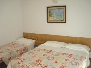 Posteľ alebo postele v izbe v ubytovaní Hotel Amalfi