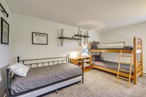 a bedroom with two bunk beds and a desk at Cozy-Chic Condo with Mtn Views 3 Mi to Slopes! in Winter Park