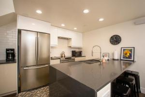 a large kitchen with a stainless steel refrigerator at Crestview Place Unit 507 in Winter Park +23 photos