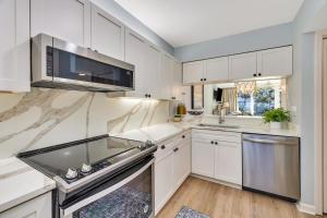 a kitchen with white cabinets and stainless steel appliances at King and Prince #176 in Harrington