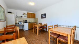 a kitchen and dining room with a table and chairs at House Vukovic in Grabovac
