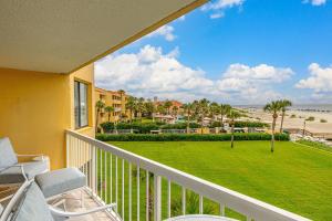 a balcony with chairs and a view of the beach at King and Prince #351 in Harrington