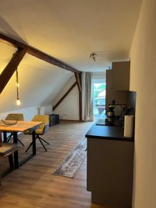 a kitchen and a living room with a table at Ferienwohnung Christl in Dillingen an der Donau