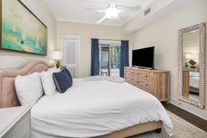 a bedroom with a white bed and a television at 400 Ocean #2207 in Saint Simons Island