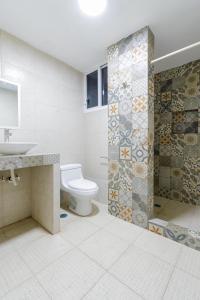 a bathroom with a toilet and a sink and a shower at Hotel Belmar in Mazatlán