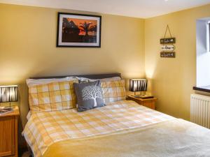 En eller flere senge i et værelse på Pottles Cottage