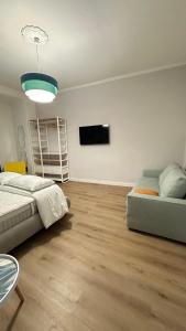 a living room with a bed and a flat screen tv at Saint Peter YH in Rome