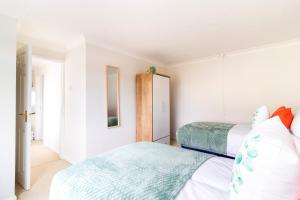 a bedroom with two beds and a mirror at Panoramic Sea View 2 bedroom Sleeps 6-Free Parking in Bournemouth