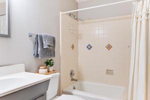 a bathroom with a tub and a sink and a toilet at Launch and Dock Lake Norman Retreat with Scenic Deck in Mooresville +27 photos