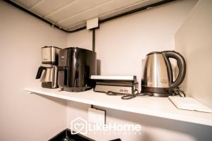 a shelf with three coffee makers on it at Royal Flat in João Pessoa