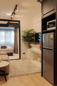 a living room with a mirror and a bed at Classic Modern Suite in Chiang Mai +35 photos