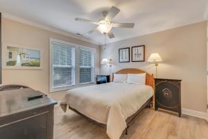a bedroom with a bed and a ceiling fan at The Pelican in Carolina Beach