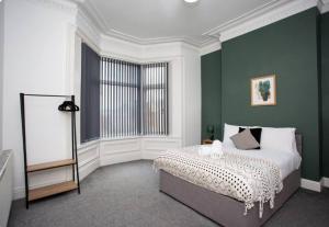 a bedroom with a bed and a large window at 3br Retreat High Barnes Wifi in Sunderland
