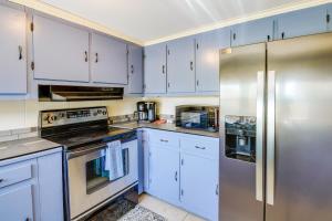 a kitchen with white cabinets and stainless steel appliances at Jefferson City Getaway - 3 Mi to Cherokee Lake! in Jefferson City