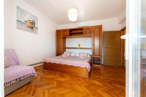 a bedroom with a bed and a chair in it at Studio in Starigrad-Paklenica 43596 in Starigrad-Paklenica +21 photos