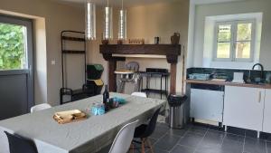 a kitchen with a table with chairs and a tableasteryasteryasteryasteryasteryastery at Maison Tiny Bwa in Saint-Cernin-de-lʼHerm