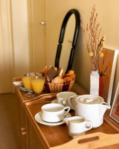 a wooden counter with cups and plates and a sink at Hôtel La Boulangerie in Grimaud +17 photos