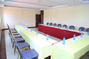 a conference room with tables and chairs with water bottles on them at Alma Hotel, Kitengela in Nairobi