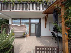 a patio with a bed and a balcony at Apartment Balatonboglar 7 in Balatonboglár
