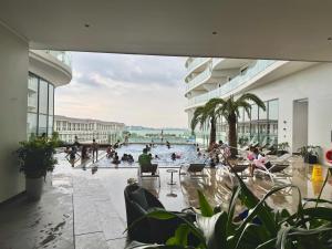 a group of people in a swimming pool in a building at The Luxury Studio Near the Seaside in Ha Long