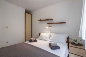 a bedroom with a white bed with towels on it at Holiday home Stari Grad - Insel Hvar 6341 in Stari Grad +42 photos