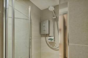 a shower in a bathroom with a glass shower at Tudor Rose Cottage in Stourpaine +45 photos