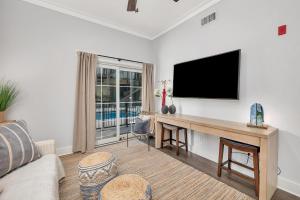 a living room with a flat screen tv on a wall at 400 Ocean #2105 in Golf Retreat