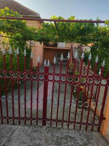 a red wrought iron fence in front of a house at Stan Uljarević in Zlatište +13 photos
