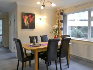 a dining room with a wooden table and chairs at Quiet Ways in Portinscale