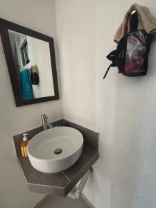a bathroom with a white sink and a mirror at CASA COLIBRÍ - Solo Mujeres! & lgbt friendly in Mérida