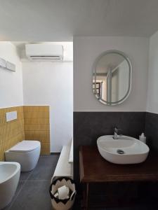 a bathroom with a sink and a toilet and a mirror at A casa di Sonia in Cerreto Guidi +35 photos
