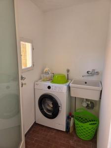 a bathroom with a washing machine and a sink at A casa di Sonia in Cerreto Guidi