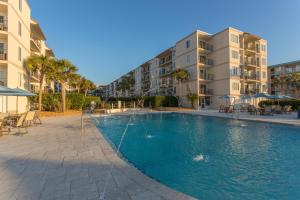 a swimming pool in front of a apartment building at Beach Club #105 in Saint Simons Island