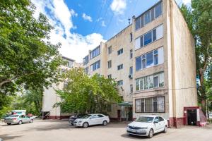 a building with cars parked in front of it at 1ком Бараева-Республика-Посольство России-Самал in Astana