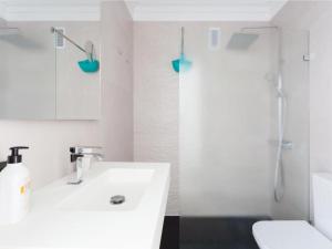 a bathroom with a white sink and a shower at Live Tabaiba Maritime in Tabaiba