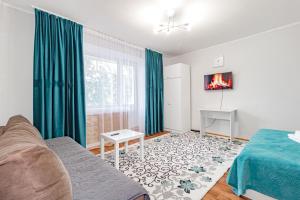 a living room with a couch and a fireplace at 1ком Бараева-Республика-Посольство России-Самал in Astana